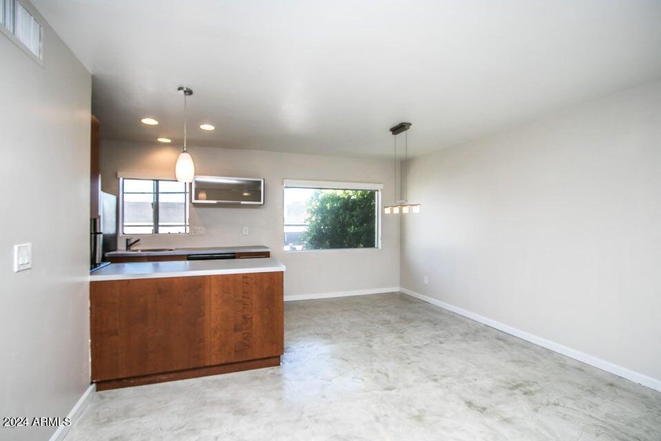 1630 East Georgia Avenue, Unit 208 Phoenix, AZ 85016 - Photo 12 of 23 a kitchen with stainless steel appliances granite countertop a stove a sink and a refrigerator
