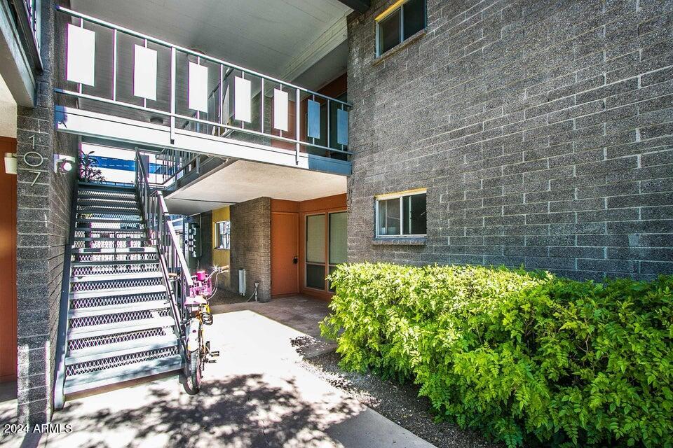 1630 East Georgia Avenue, Unit 208 Phoenix, AZ 85016 - Photo 2 of 23 a front view of a building with a garden