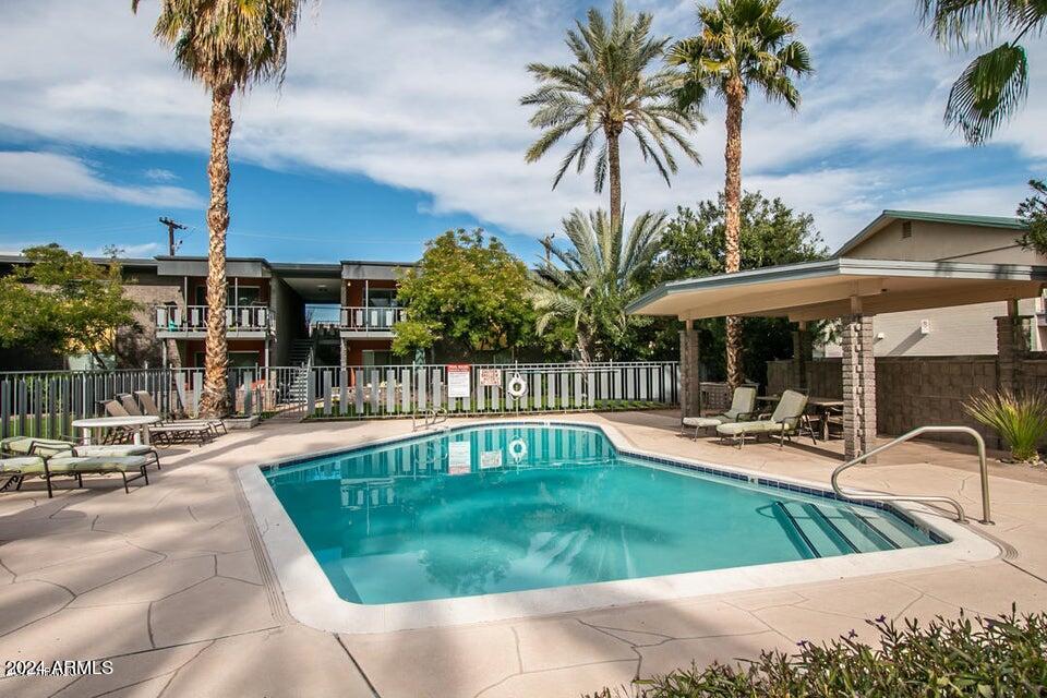 1630 East Georgia Avenue, Unit 208 Phoenix, AZ 85016 - Photo 23 of 23 a view of a swimming pool with a patio and a garden
