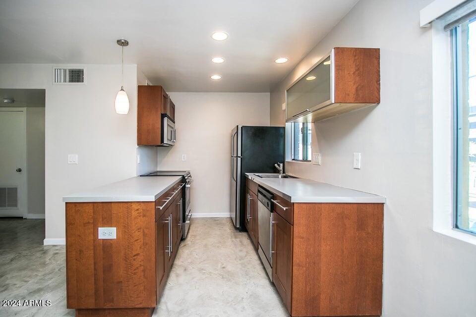 1630 East Georgia Avenue, Unit 208 Phoenix, AZ 85016 - Photo 5 of 23 a kitchen with stainless steel appliances granite countertop a stove a sink and a refrigerator