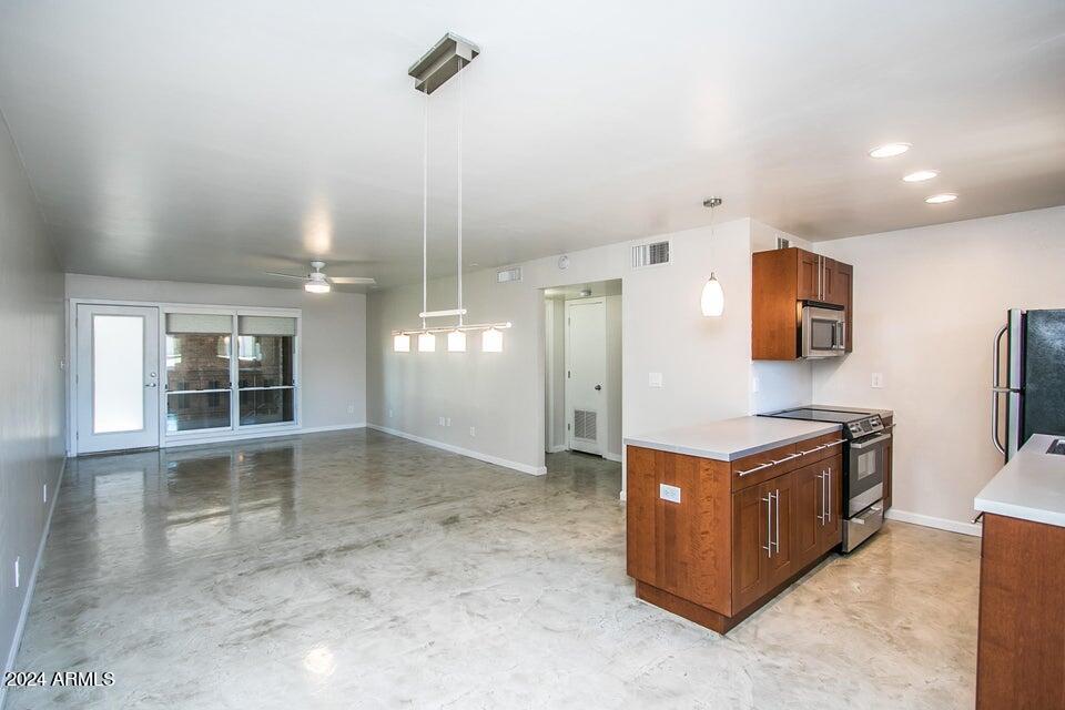 1630 East Georgia Avenue, Unit 208 Phoenix, AZ 85016 - Photo 6 of 23 an open kitchen with stainless steel appliances granite countertop a stove and a sink