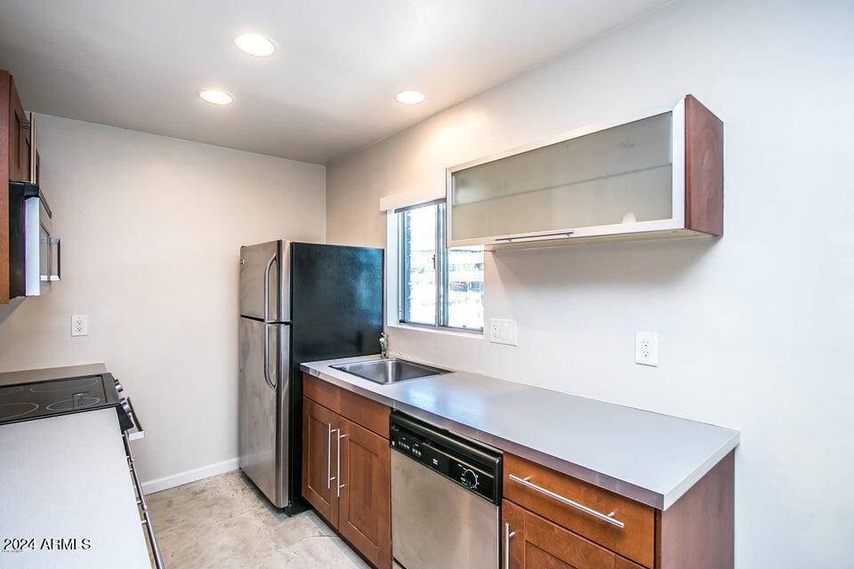 1630 East Georgia Avenue, Unit 208 Phoenix, AZ 85016 - Photo 8 of 23 a kitchen with stainless steel appliances a refrigerator and a stove