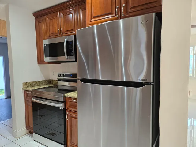 a close view of a stove top oven and refrigerator