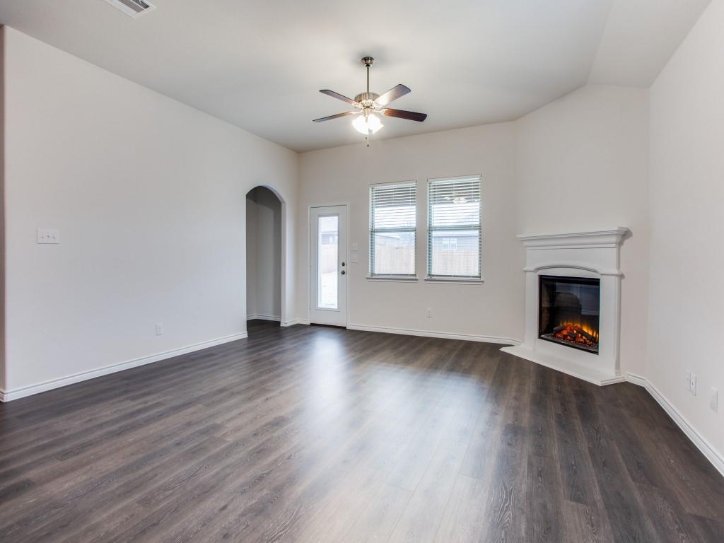 123 Lakeview Circle Pilot Point, TX 76258 - Photo 12 of 39 an empty room with wooden floor chandelier and windows