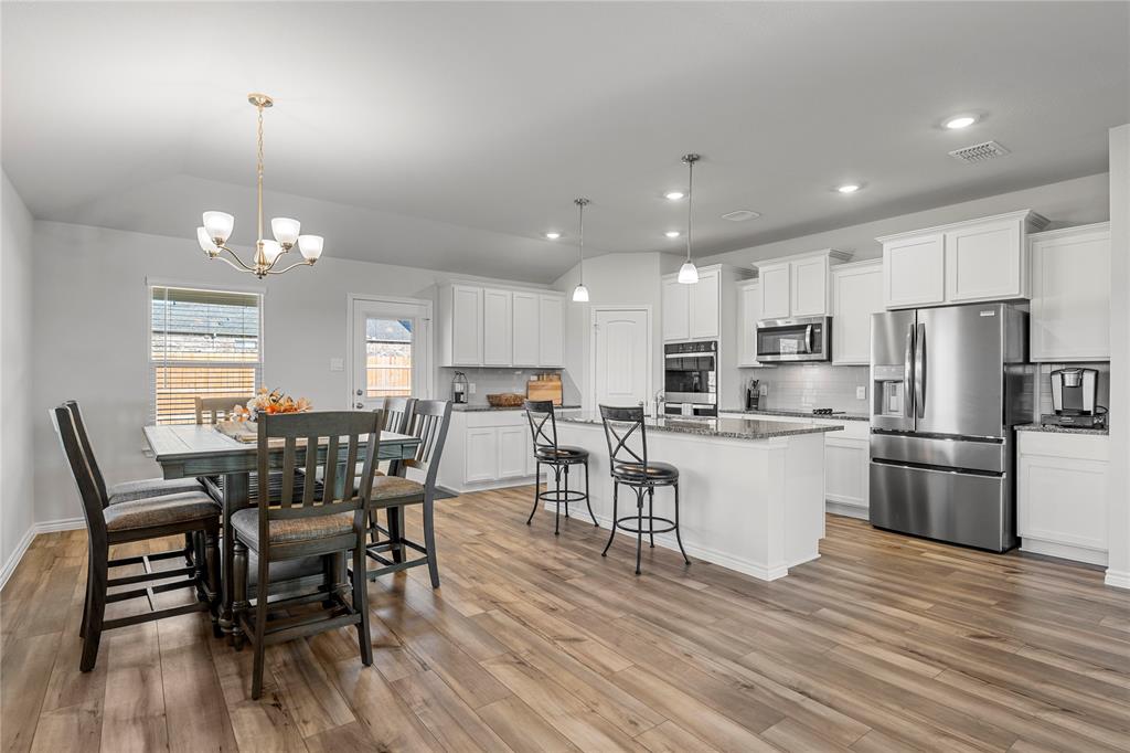 10761 Chesson Flts Drive Waco, TX 76708 - Photo 14 of 30 a view of a dining room with furniture a kitchen and chandelier