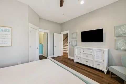 a bedroom with a large bed and a chandelier