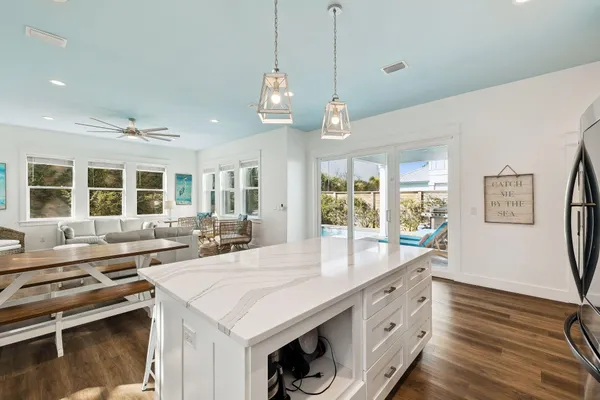 a bedroom with a bed a flat screen tv and a chandelier