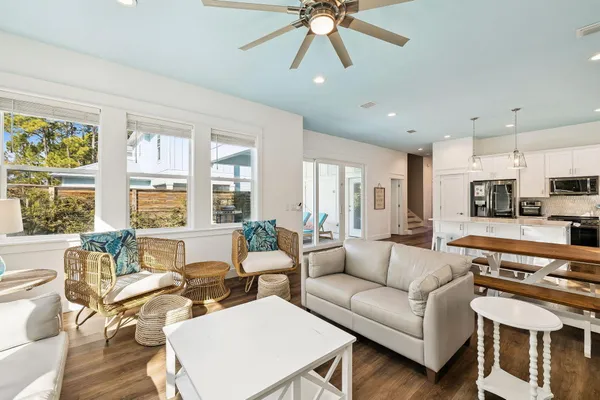 a large kitchen with stainless steel appliances kitchen island granite countertop a stove a sink dishwasher and a microwave with wooden floor