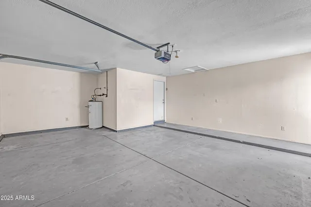 a front view of a house with a yard and potted plants