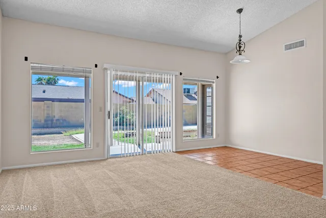 a view of an empty room with glass door