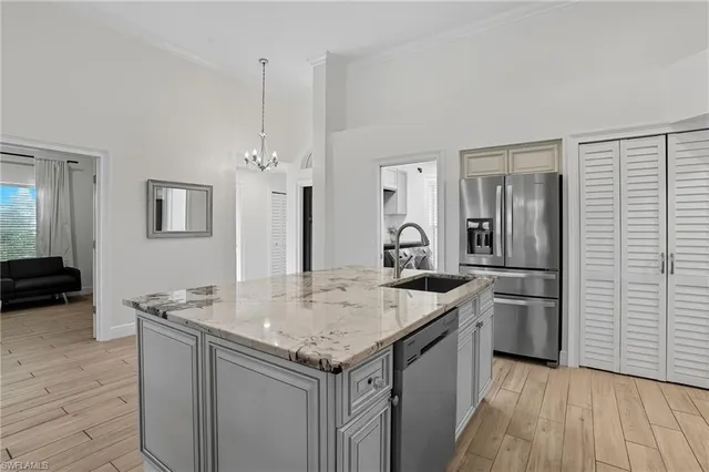 a kitchen with stainless steel appliances granite countertop a sink stove and refrigerator