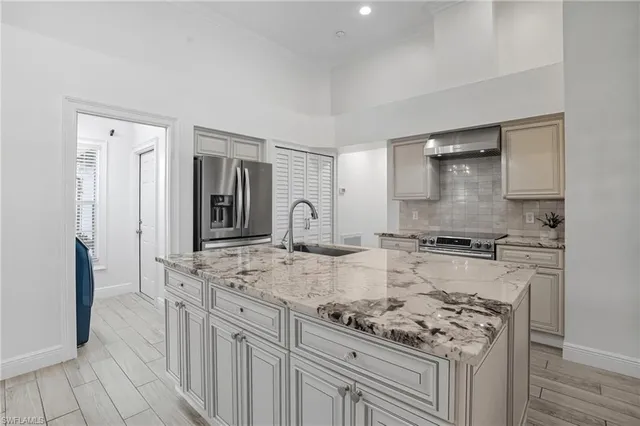 a kitchen with stainless steel appliances granite countertop a stove sink and cabinets