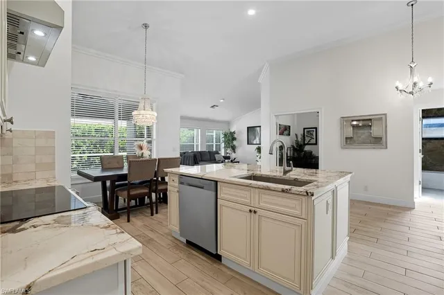 a kitchen with sink cabinets and dining table chair