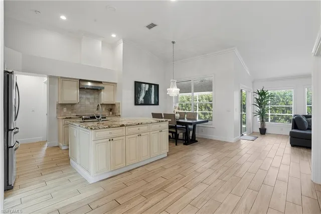 a kitchen with stainless steel appliances granite countertop a stove and a wooden floors
