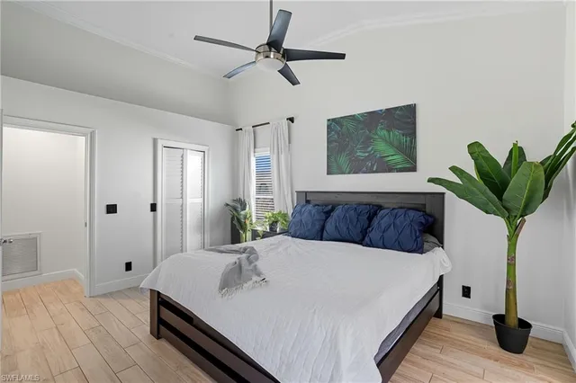 a bed sitting in a spacious bedroom next to a window