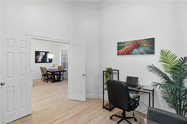 a view of a workspace with furniture and a window