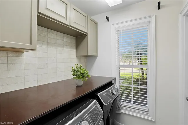 a view of a room that has a window and wooden floor
