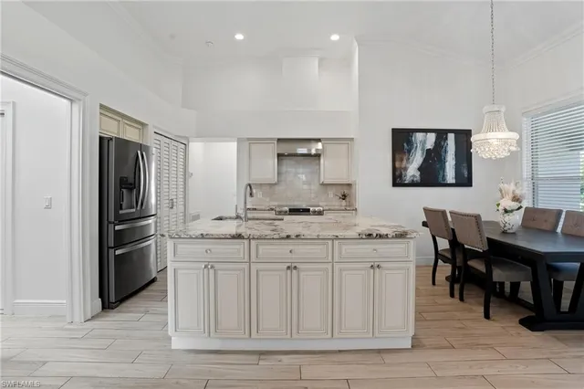 a kitchen with center island and stainless steel appliances