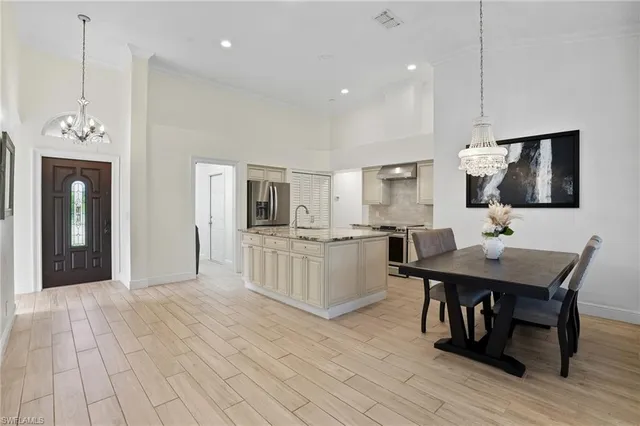 a living room with furniture a flat screen tv and kitchen view
