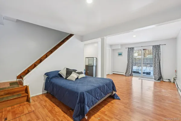 a spacious bedroom with a large bed and a wooden floor