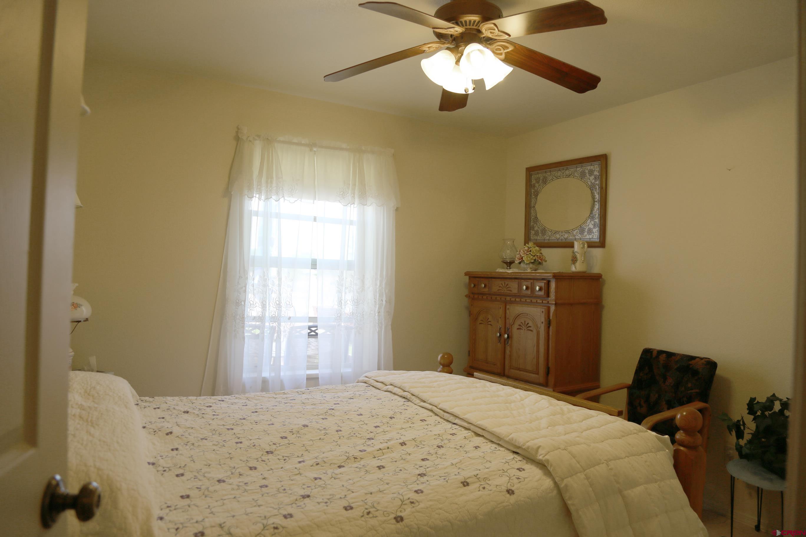 20287 Fox Ridge Drive Austin, CO 81410 - Photo 14 of 16 a bedroom with a bed and wooden floor
