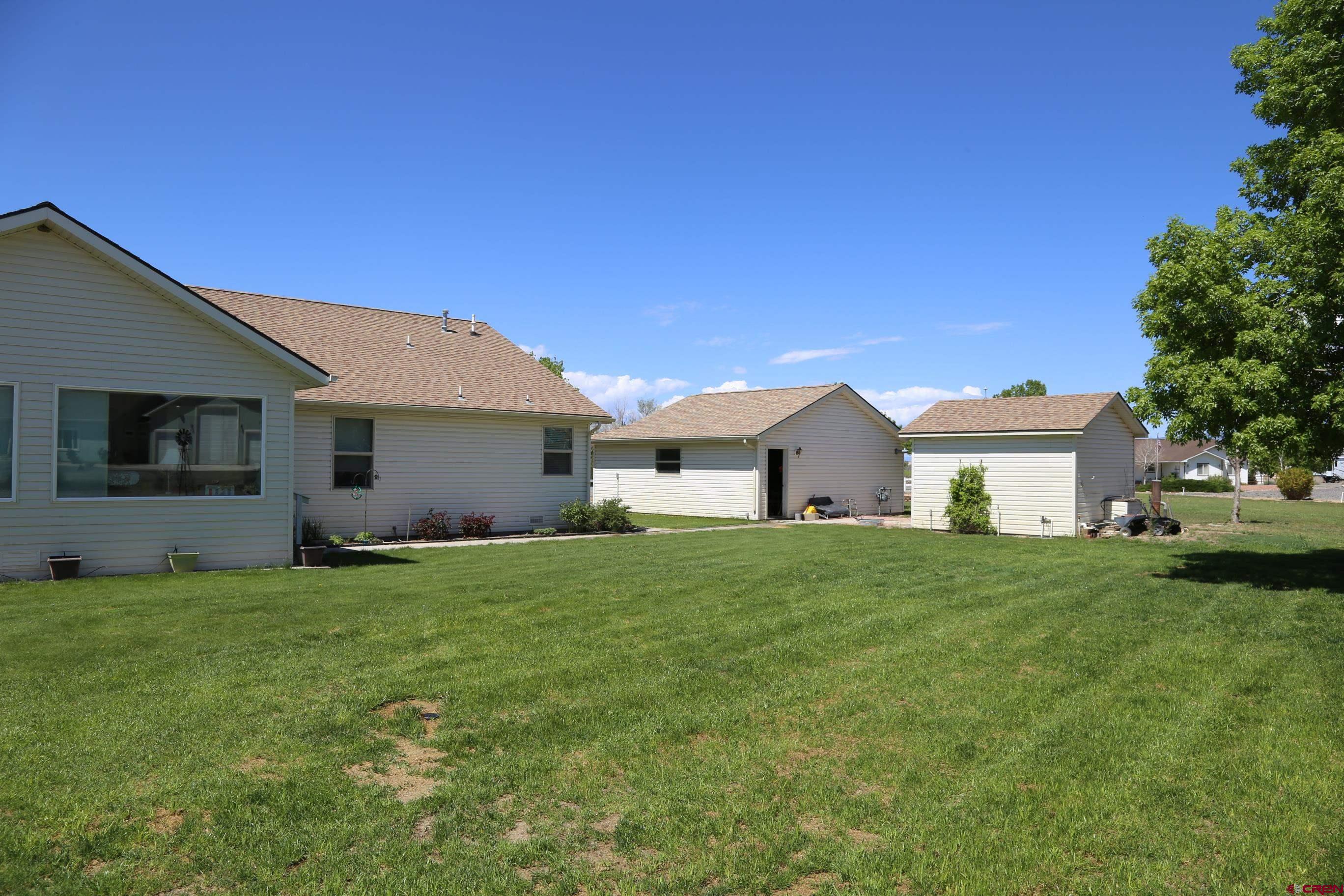 20287 Fox Ridge Drive Austin, CO 81410 - Photo 5 of 16 a view of a yard in front of a house with large trees