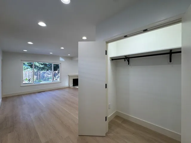 a view of a backyard with wooden fence