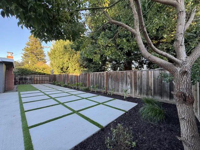 a view of a house with backyard and sitting area