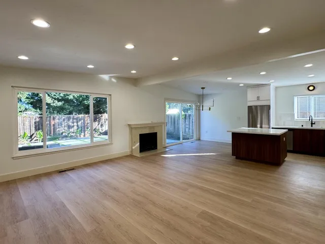 a view of kitchen with kitchen island microwave and wooden floor