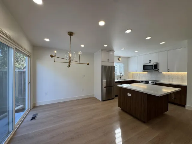 a large kitchen with stainless steel appliances granite countertop a large counter top and stove