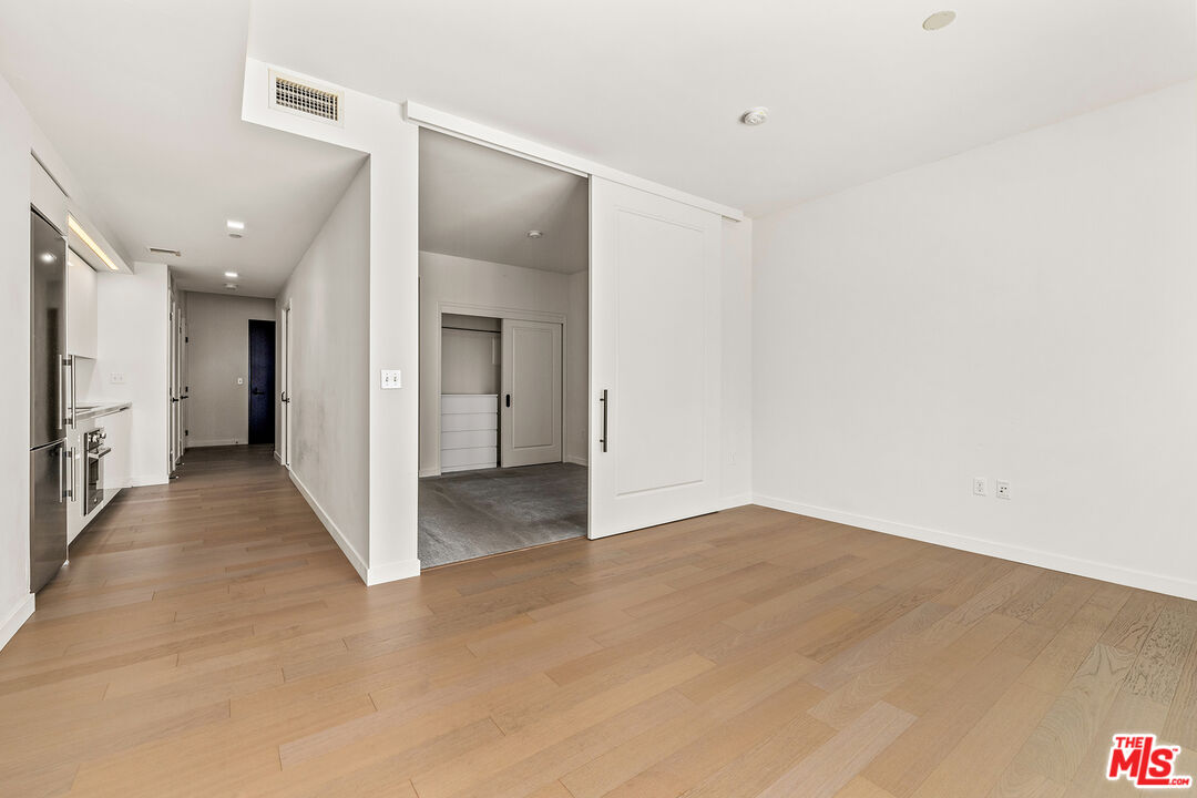 1050 South Grand Avenue, Unit 1405 Los Angeles, CA 90015 - Photo 5 of 11 a view of a hallway with wooden floor