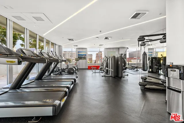 a view of a gym room with gym equipment