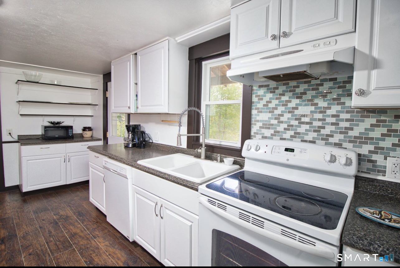 15 Lower Road North Canaan, CT 06018 - Photo 13 of 36 a kitchen with a stove a sink and white cabinets