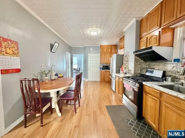 a view of a dining room with furniture and a kitchen