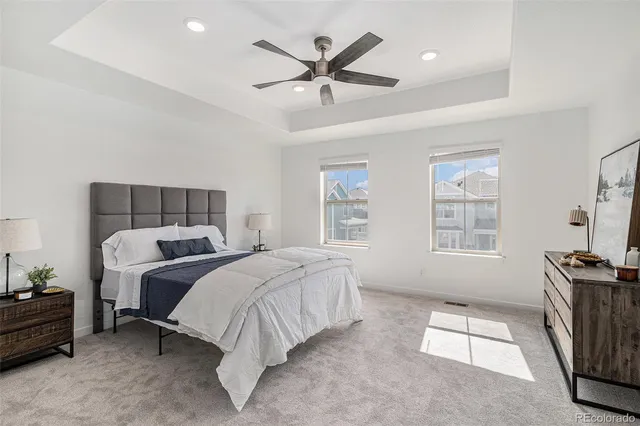 a bed room with a bed and a ceiling fan