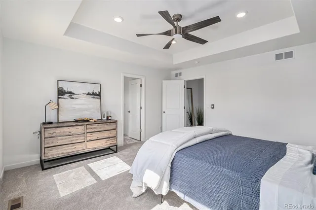 a bedroom with a bed and a painting on the wall