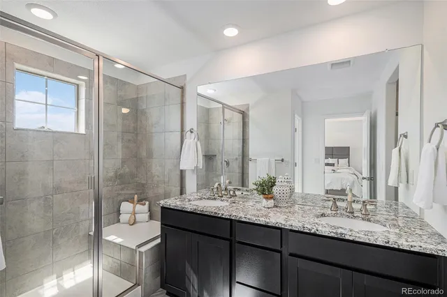 a bathroom with a granite countertop sink mirror and double