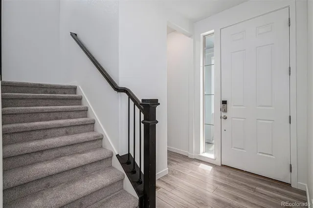 a view of entryway with wooden floor and stairs