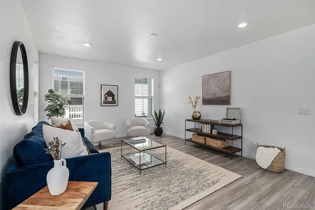 a living room with furniture and a potted plant