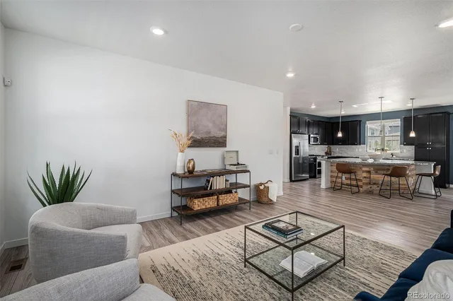 a living room with furniture and kitchen view