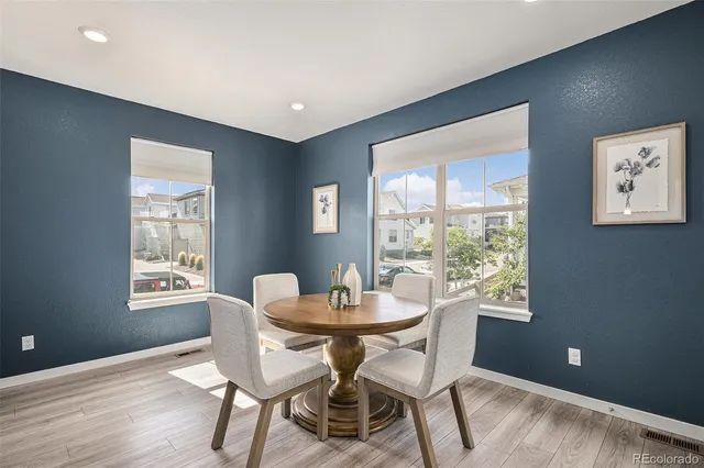 a dining room with furniture and window
