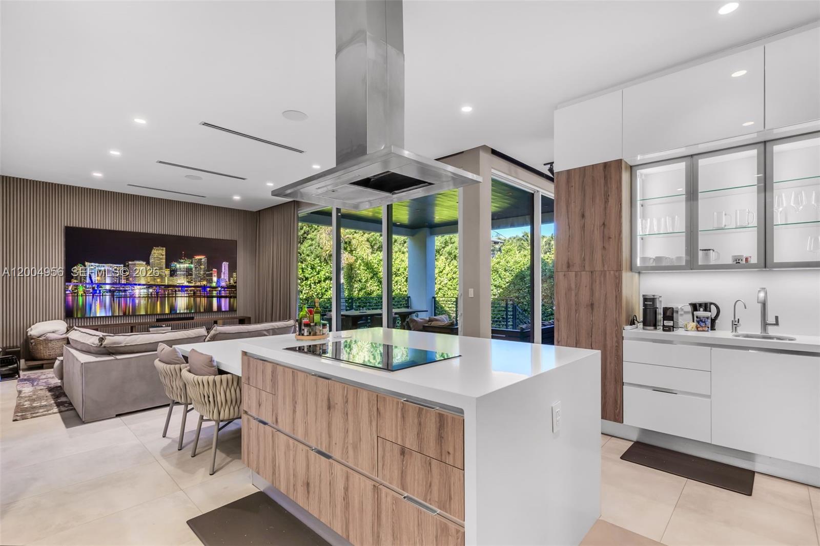 285 West Mashta Drive Key Biscayne, FL 33149 - Photo 12 of 42 a kitchen with sink cabinets and outdoor living space