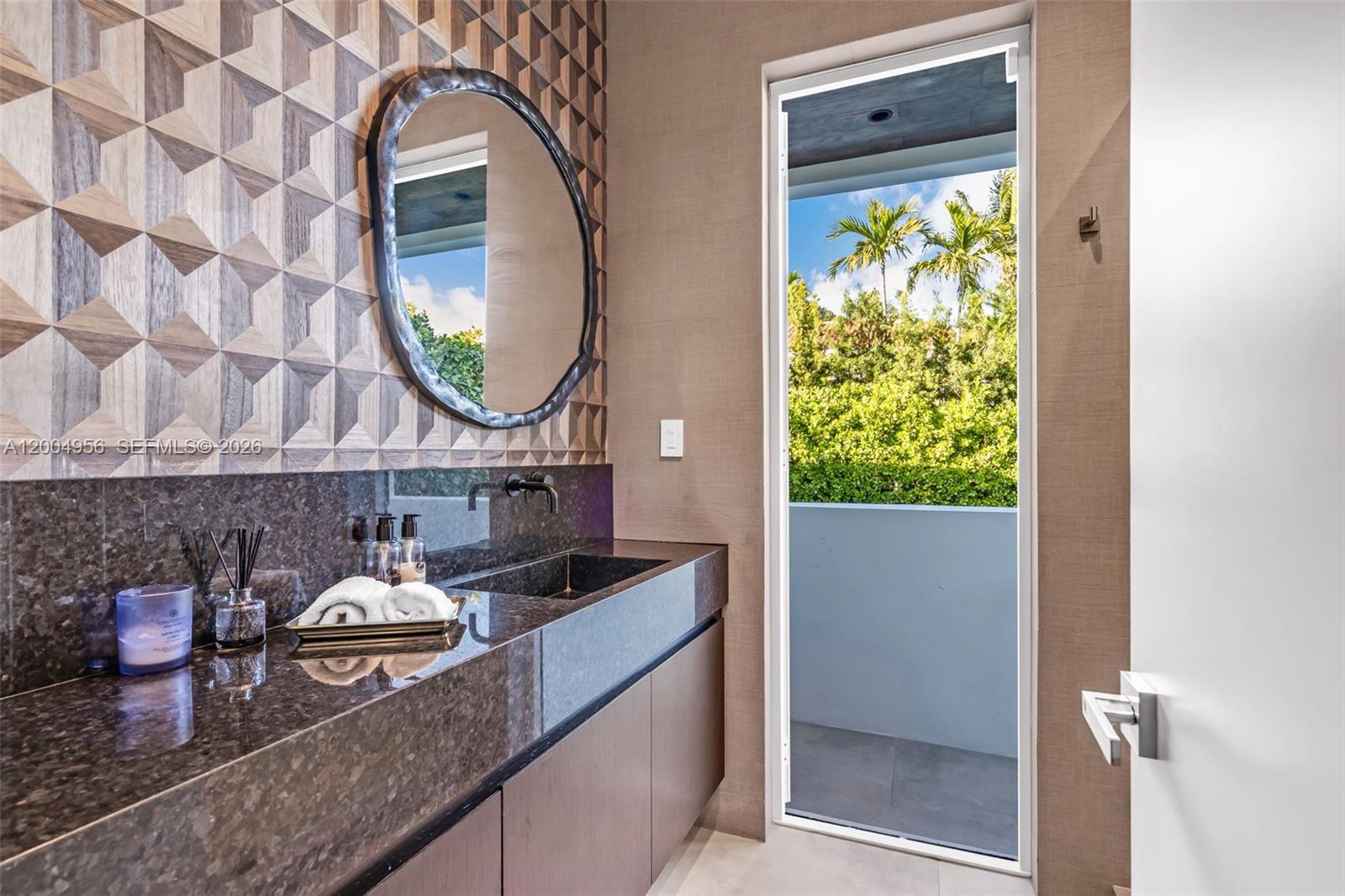 285 West Mashta Drive Key Biscayne, FL 33149 - Photo 15 of 42 a bathroom with a granite countertop sink and a mirror