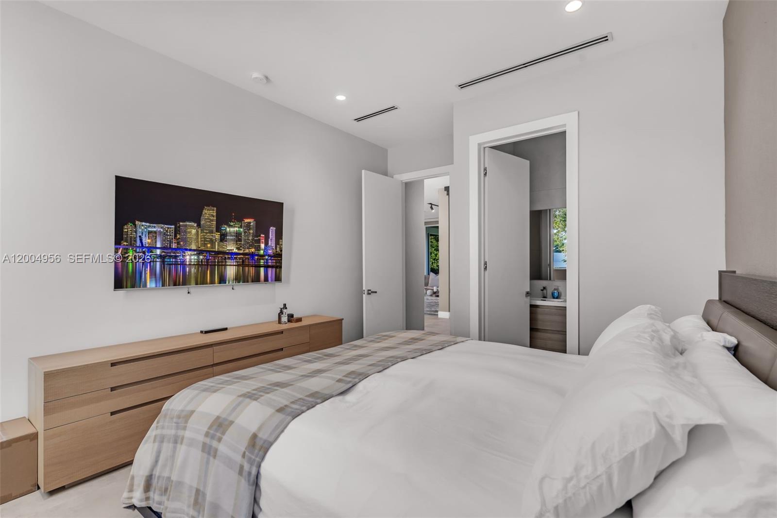 285 West Mashta Drive Key Biscayne, FL 33149 - Photo 17 of 42 a bedroom with a bed and a large mirror