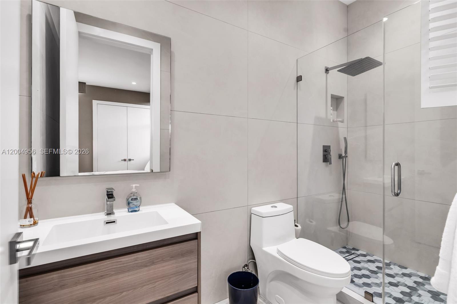285 West Mashta Drive Key Biscayne, FL 33149 - Photo 18 of 42 a bathroom with a sink toilet a mirror and shower