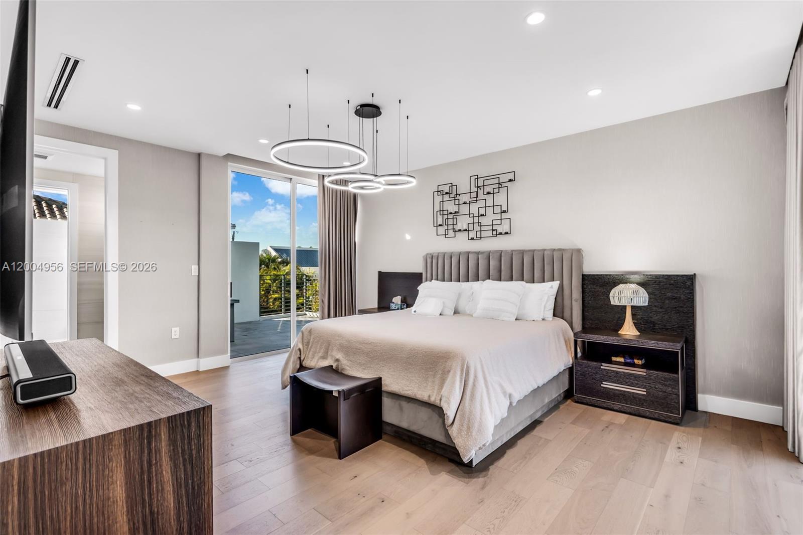 285 West Mashta Drive Key Biscayne, FL 33149 - Photo 19 of 42 a spacious bedroom with a bed and a desk