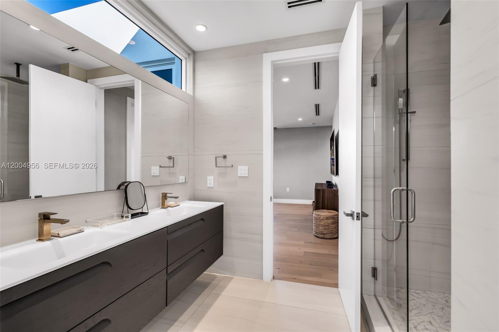 285 West Mashta Drive Key Biscayne, FL 33149 - Photo 24 of 42 a en suite bathroom with a double vanity sink and a mirror
