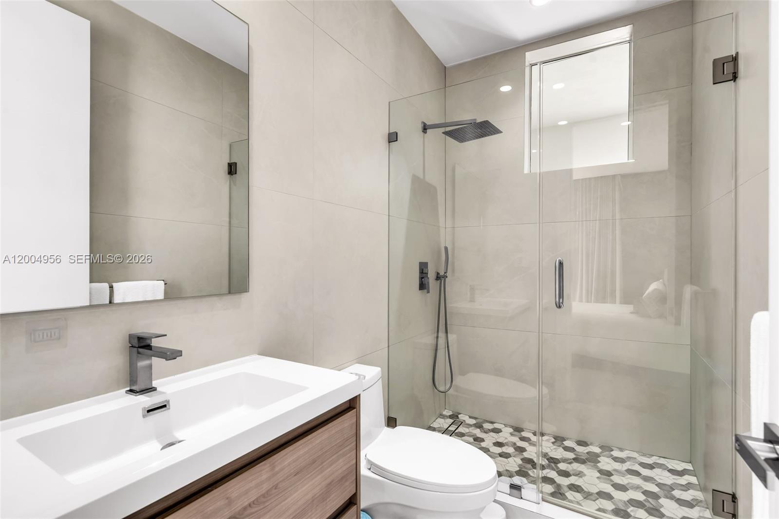 285 West Mashta Drive Key Biscayne, FL 33149 - Photo 29 of 42 a bathroom with a sink a toilet and shower