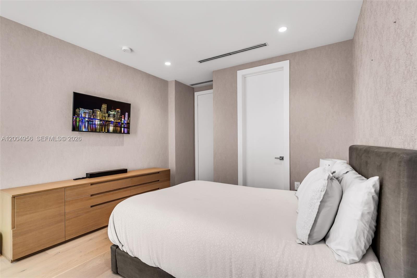 285 West Mashta Drive Key Biscayne, FL 33149 - Photo 31 of 42 a bedroom with a bed and a painting on the wall
