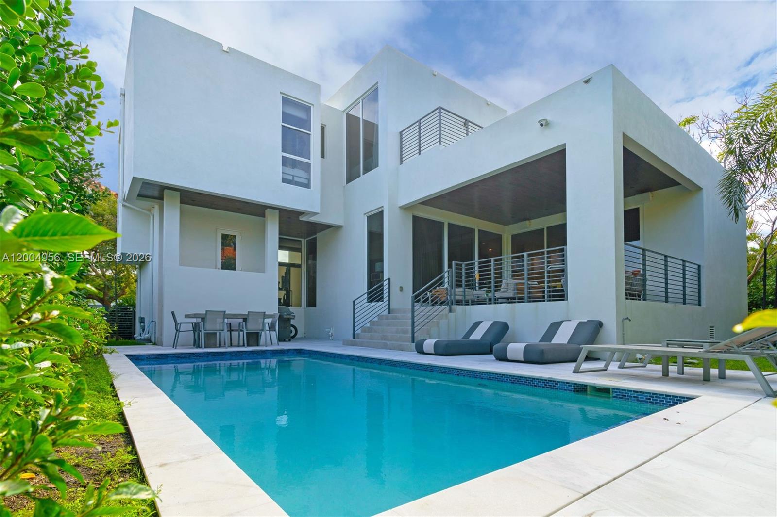 285 West Mashta Drive Key Biscayne, FL 33149 - Photo 35 of 42 a view of a house with swimming pool and sitting area